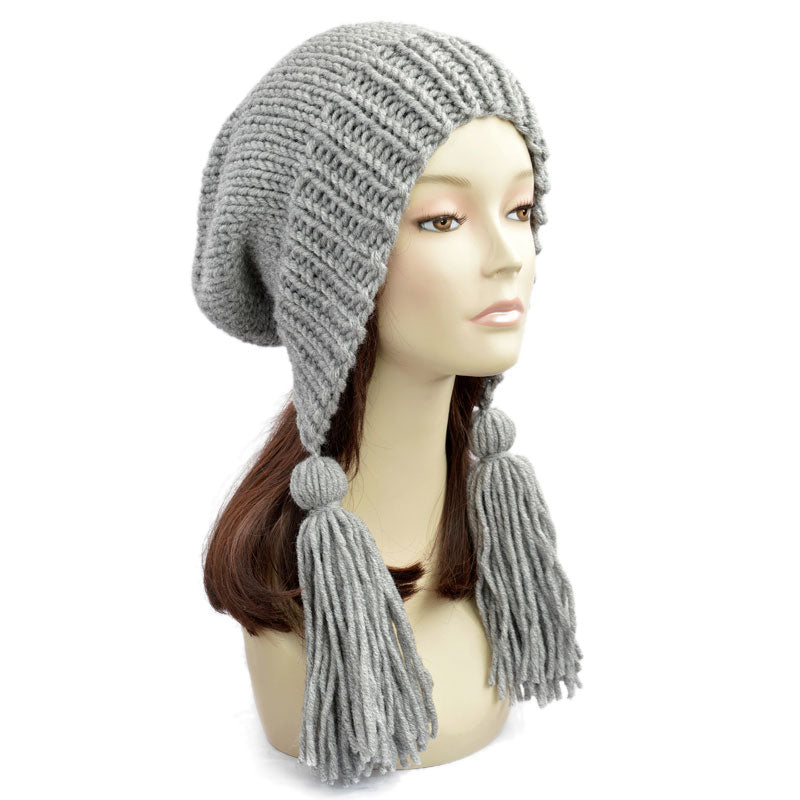 Knitted slouchy beanie with tassels from StopFrost. Our oversized beanie is available in any size and color. Grey slouchy beanie with tassel for men and women. A wide brim and large fluffy tassels are characteristic features of this slouchy beanie tassel.